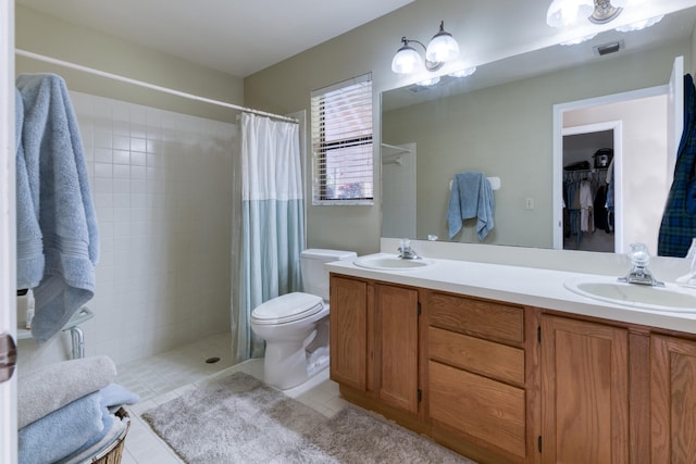 bathroom with tile patterned flooring, vanity, curtained shower, and toilet