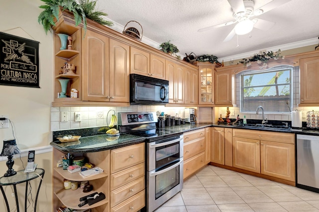 kitchen featuring sink, backsplash, stainless steel appliances, light tile patterned flooring, and dark stone counters