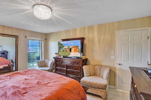 bedroom with baseboards, a textured ceiling, an inviting chandelier, and light tile patterned floors