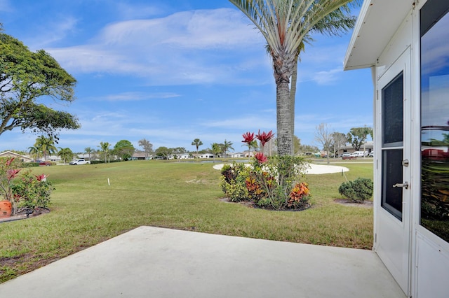 view of yard featuring a residential view and a patio