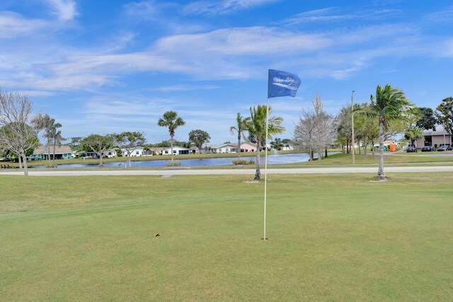 surrounding community featuring a lawn, a water view, and a residential view