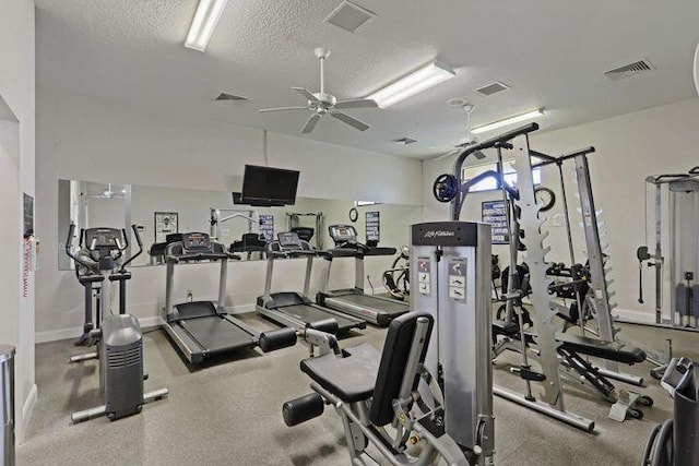 exercise room with visible vents, ceiling fan, a textured ceiling, and baseboards