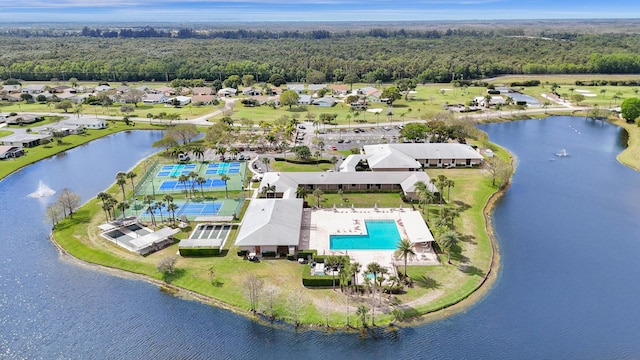 birds eye view of property featuring a water view and a view of trees