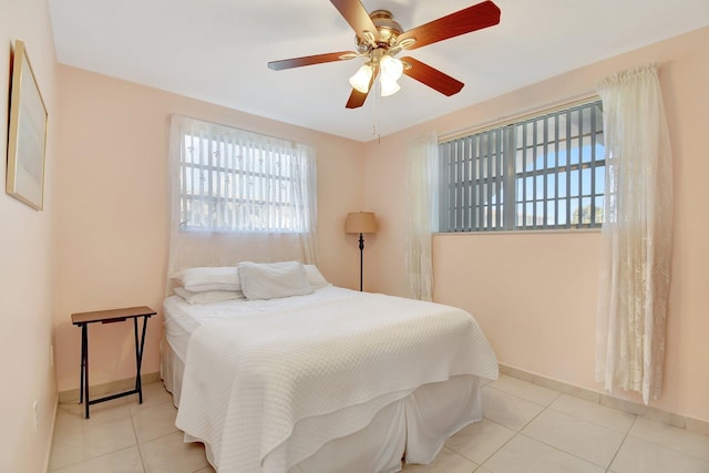 bedroom with light tile patterned floors and ceiling fan