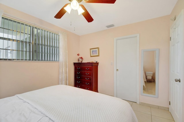 tiled bedroom featuring ceiling fan