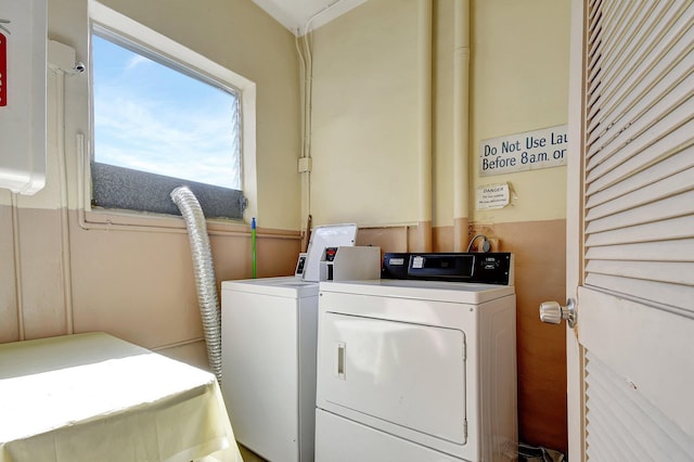 clothes washing area with washer and dryer