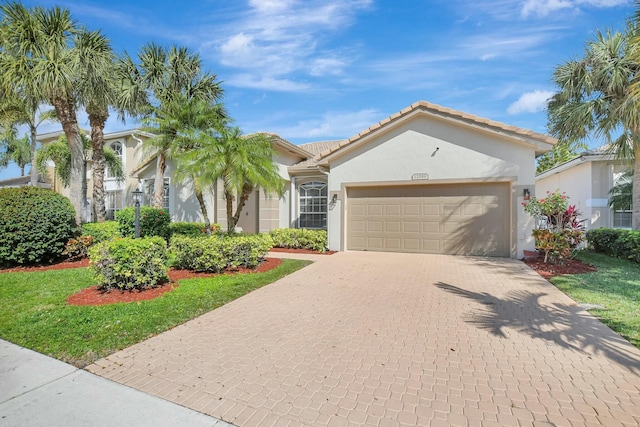 view of front of home with a garage and a front yard