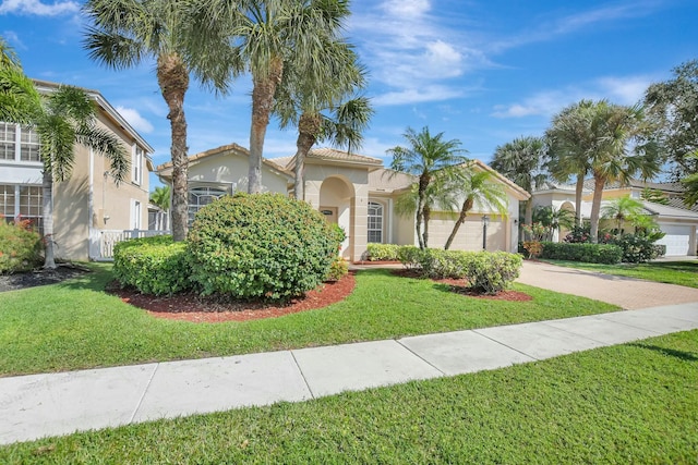 mediterranean / spanish-style home with a garage and a front yard