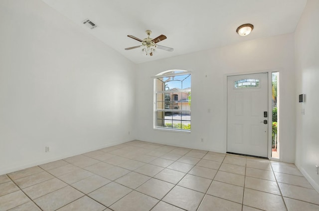 tiled entryway featuring lofted ceiling and ceiling fan