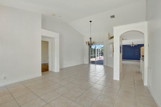 unfurnished room featuring vaulted ceiling, ceiling fan with notable chandelier, and light tile patterned floors