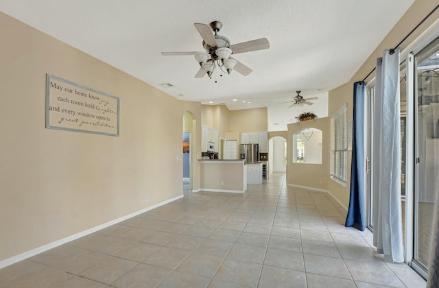 spare room featuring ceiling fan and light tile patterned floors