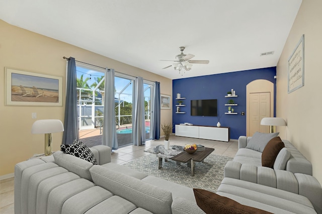 living room with light tile patterned floors and ceiling fan