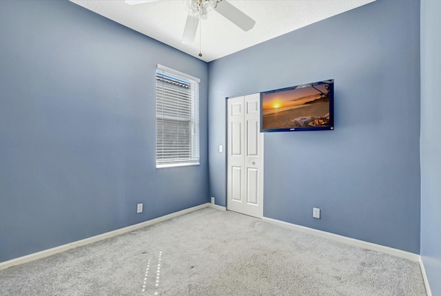 carpeted empty room with ceiling fan