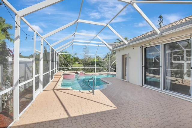 view of swimming pool with a lanai, a patio, and an in ground hot tub