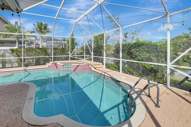 view of pool featuring an in ground hot tub, glass enclosure, and a patio area