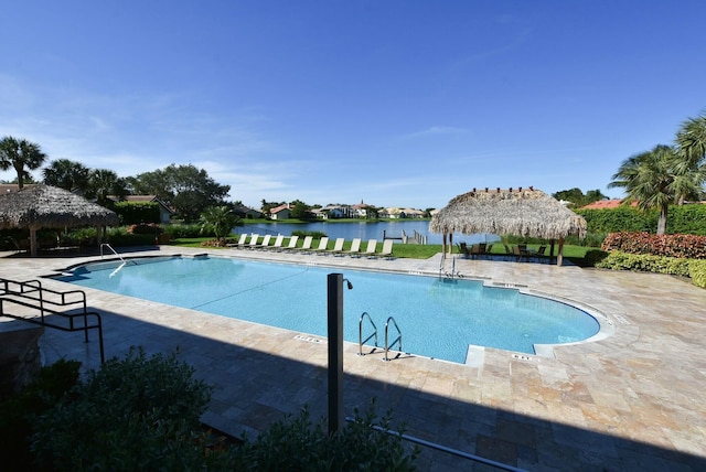 view of pool with a gazebo and a water view