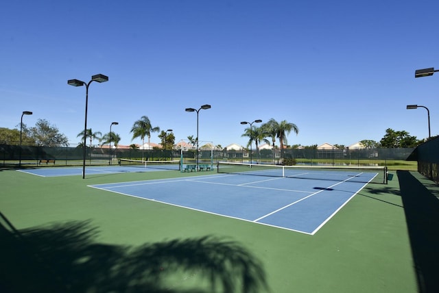 view of tennis court featuring basketball hoop