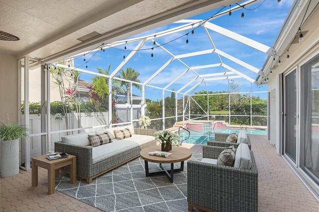 view of patio / terrace featuring a swimming pool with hot tub, outdoor lounge area, and glass enclosure