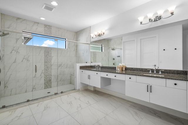 bathroom featuring vanity and a shower with shower door