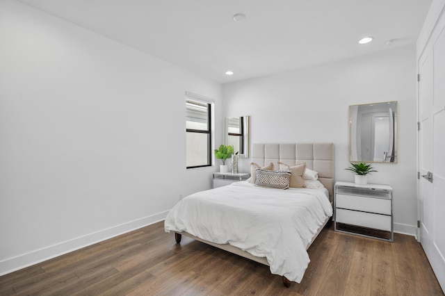 bedroom with dark hardwood / wood-style flooring