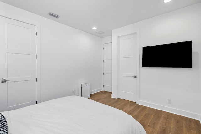 bedroom featuring dark hardwood / wood-style flooring