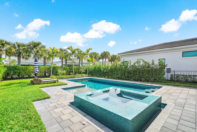 view of swimming pool featuring a patio and an in ground hot tub