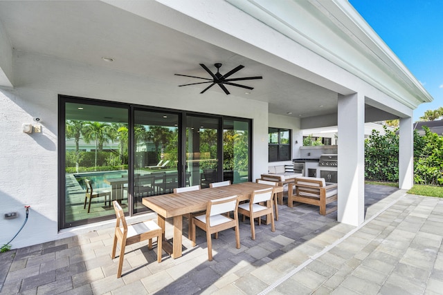 view of patio with exterior kitchen, grilling area, and ceiling fan