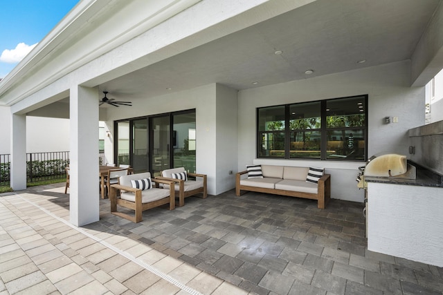 view of patio / terrace with outdoor lounge area, ceiling fan, and an outdoor kitchen