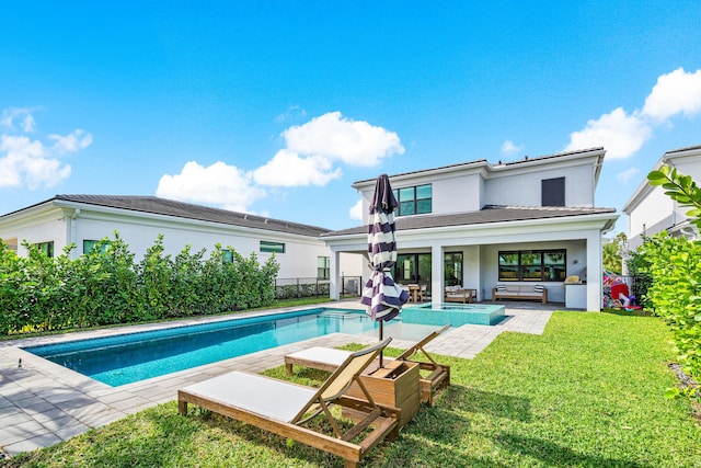 back of house featuring a fenced in pool, a lawn, a patio, and an outdoor hangout area