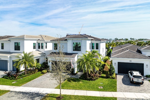 view of front of home featuring a garage and a front yard