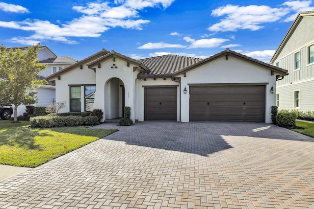 view of front facade with a garage and a front lawn