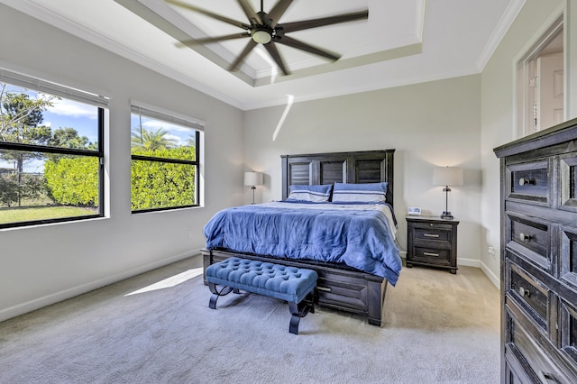 carpeted bedroom featuring a raised ceiling, crown molding, and ceiling fan