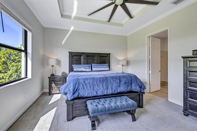 carpeted bedroom featuring crown molding, a tray ceiling, and ceiling fan