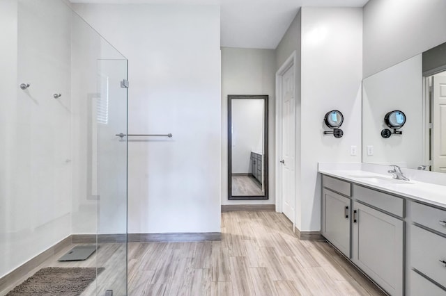 bathroom with vanity, hardwood / wood-style floors, and walk in shower