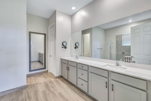 bathroom featuring an enclosed shower, vanity, and hardwood / wood-style floors