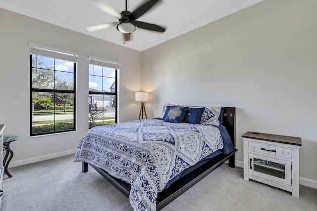 bedroom with crown molding, ceiling fan, and light carpet