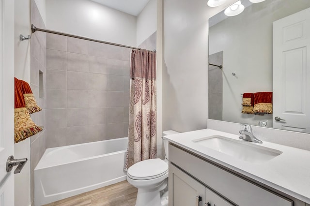 full bathroom featuring vanity, hardwood / wood-style floors, shower / bath combination with curtain, and toilet