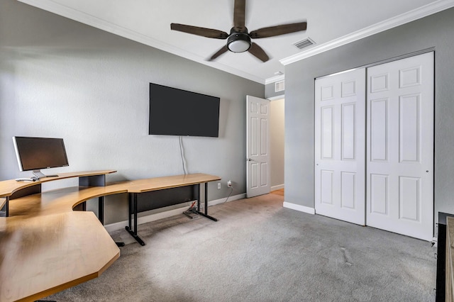 carpeted office featuring crown molding and ceiling fan