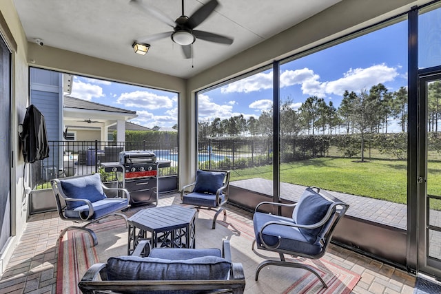 sunroom featuring plenty of natural light and ceiling fan