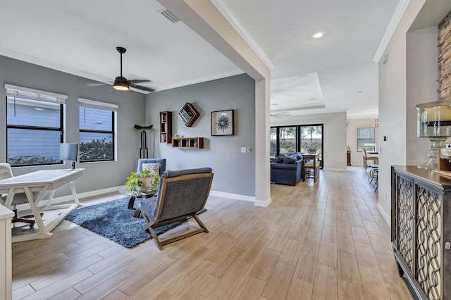 living room featuring ornamental molding, ceiling fan, and light wood-type flooring