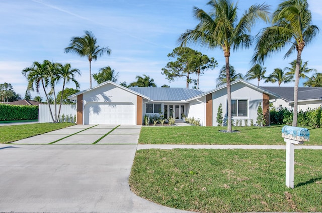 single story home featuring a garage and a front lawn