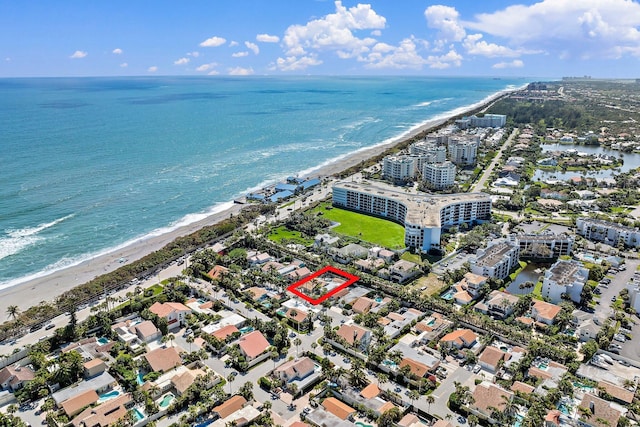 birds eye view of property featuring a water view and a view of the beach