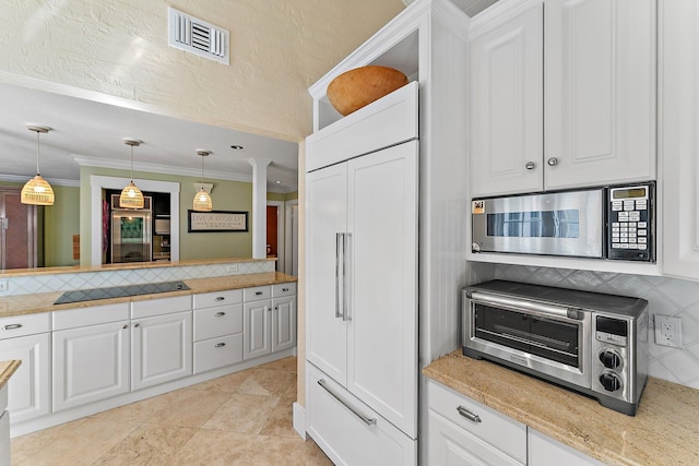 kitchen with white cabinetry, hanging light fixtures, backsplash, and black electric cooktop