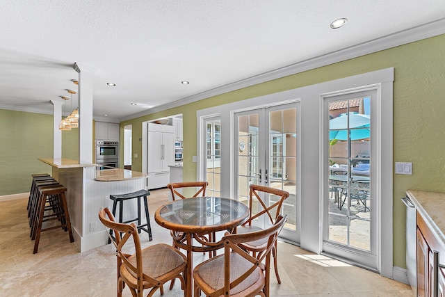 dining space featuring french doors, crown molding, and a textured ceiling