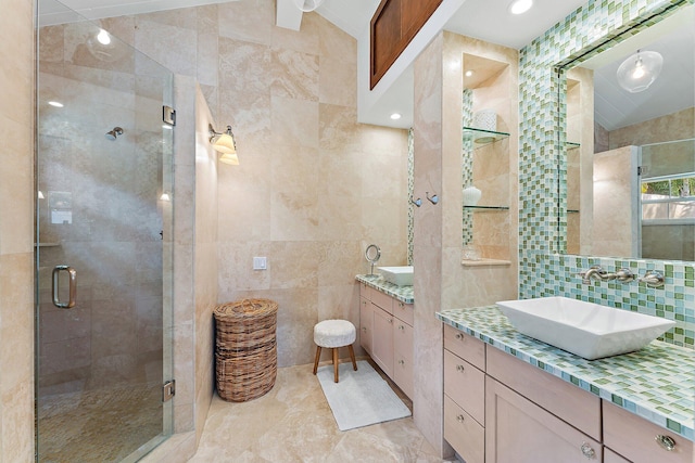 bathroom with a shower with shower door, lofted ceiling, tile walls, decorative backsplash, and vanity