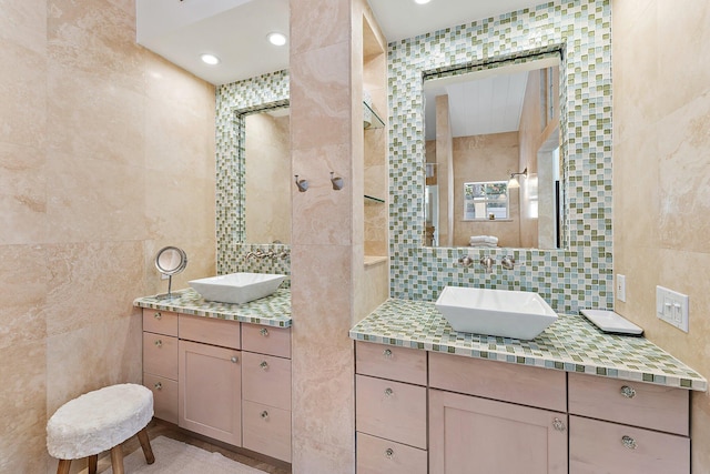 bathroom featuring tile walls, vanity, and decorative backsplash