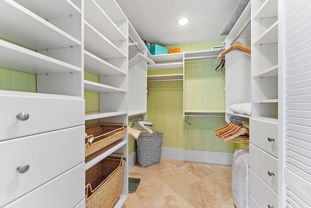 walk in closet with light tile patterned flooring