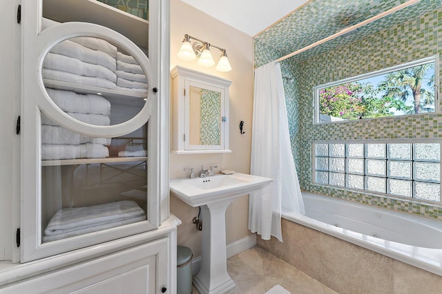 bathroom featuring shower / bathtub combination with curtain, sink, and tile patterned flooring