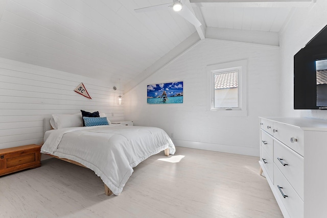 bedroom featuring lofted ceiling with beams, ceiling fan, wooden walls, and light hardwood / wood-style floors