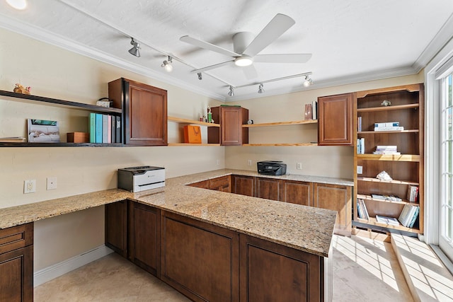 kitchen with ornamental molding, light stone countertops, ceiling fan, and kitchen peninsula